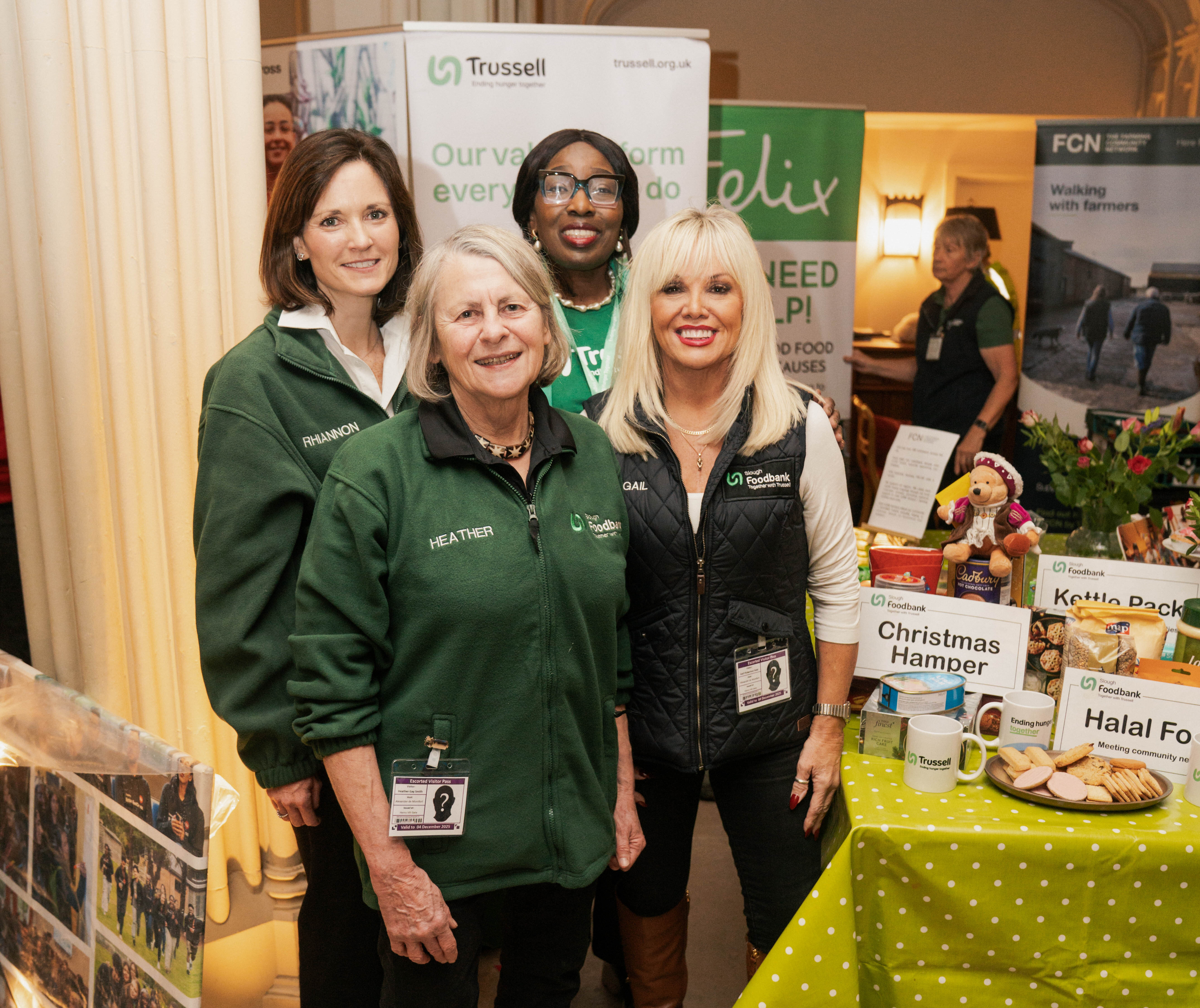 Sloug foodbank volunteers stand next to a table inside Windsor Castle