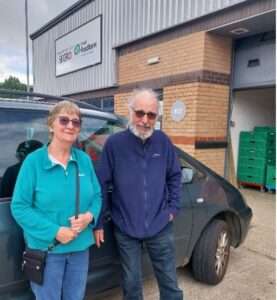 Volunteer drivers stand by their car